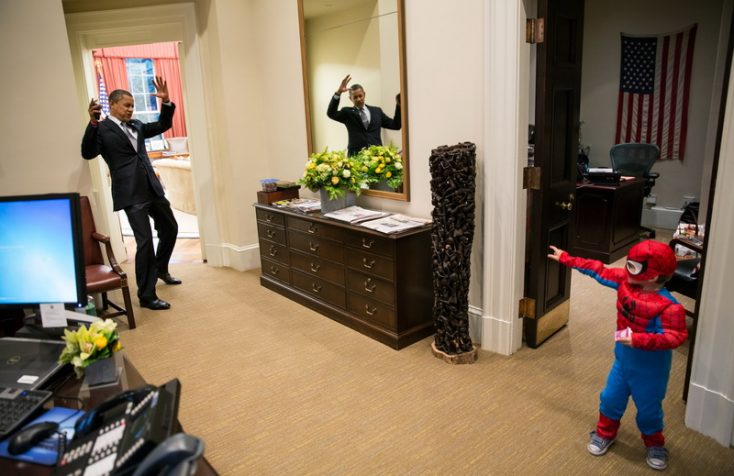 Barack Obama and a child in a Spider-Man costume.